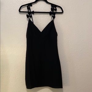 Black dress with bow strap details.